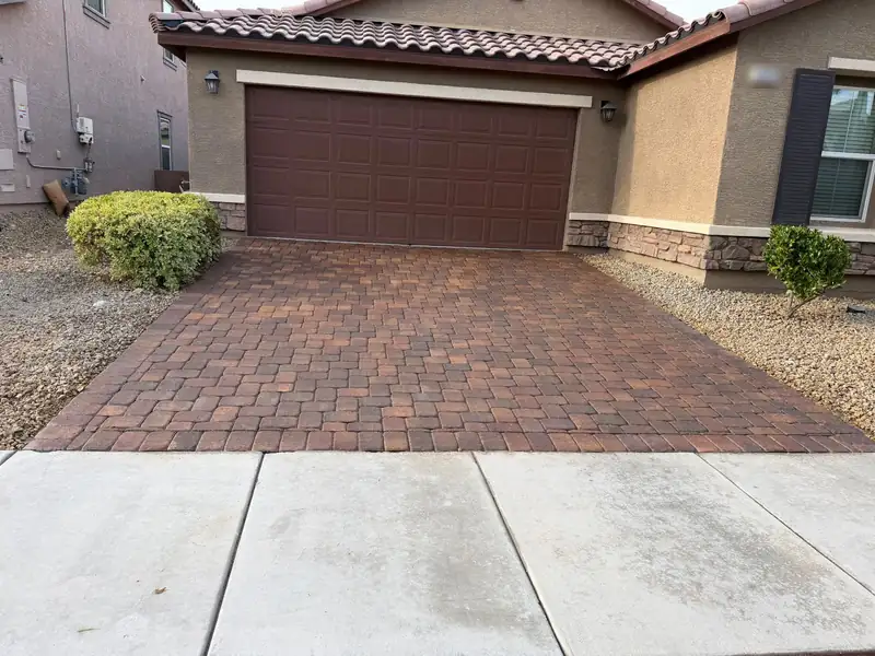 The same driveway after cleaning, stain treatment and sealing